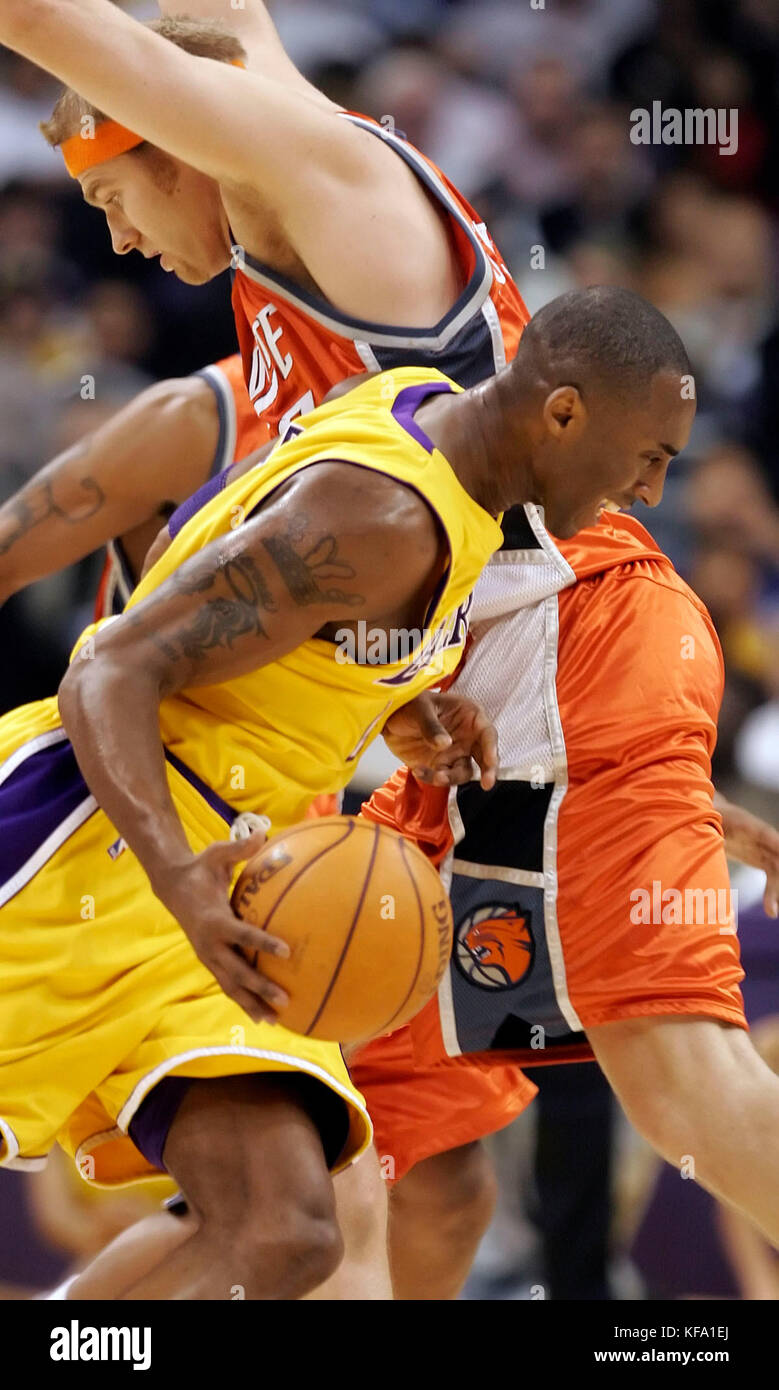 Los Angeles Lakers' Kobe Bryant, foreground, tries to dribble past Charlotte Bobcats' Jake Voskuhl in the first half in Los Angeles on Friday, Oct. 21, 2005. Photo by Francis Specker Stock Photo