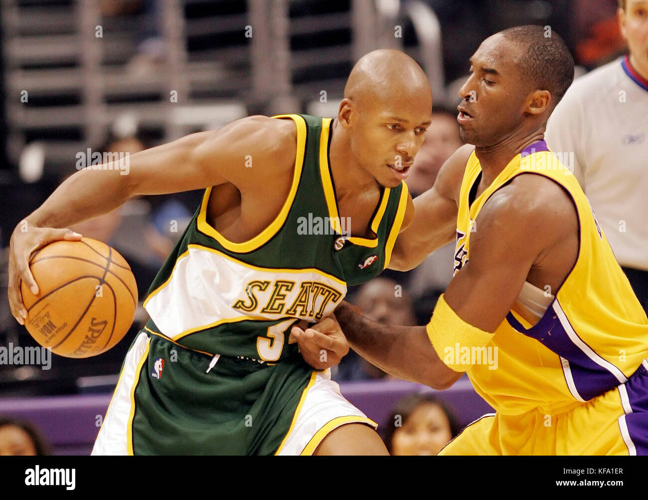 Seattle SuperSonics' Ray Allen, left, tries to dribble past Los Angeles Lakers' Kobe Bryant in the fourth quarter in Los Angeles on Thursday, Nov. 24, 2005. Photo by Francis Specker Stock Photo