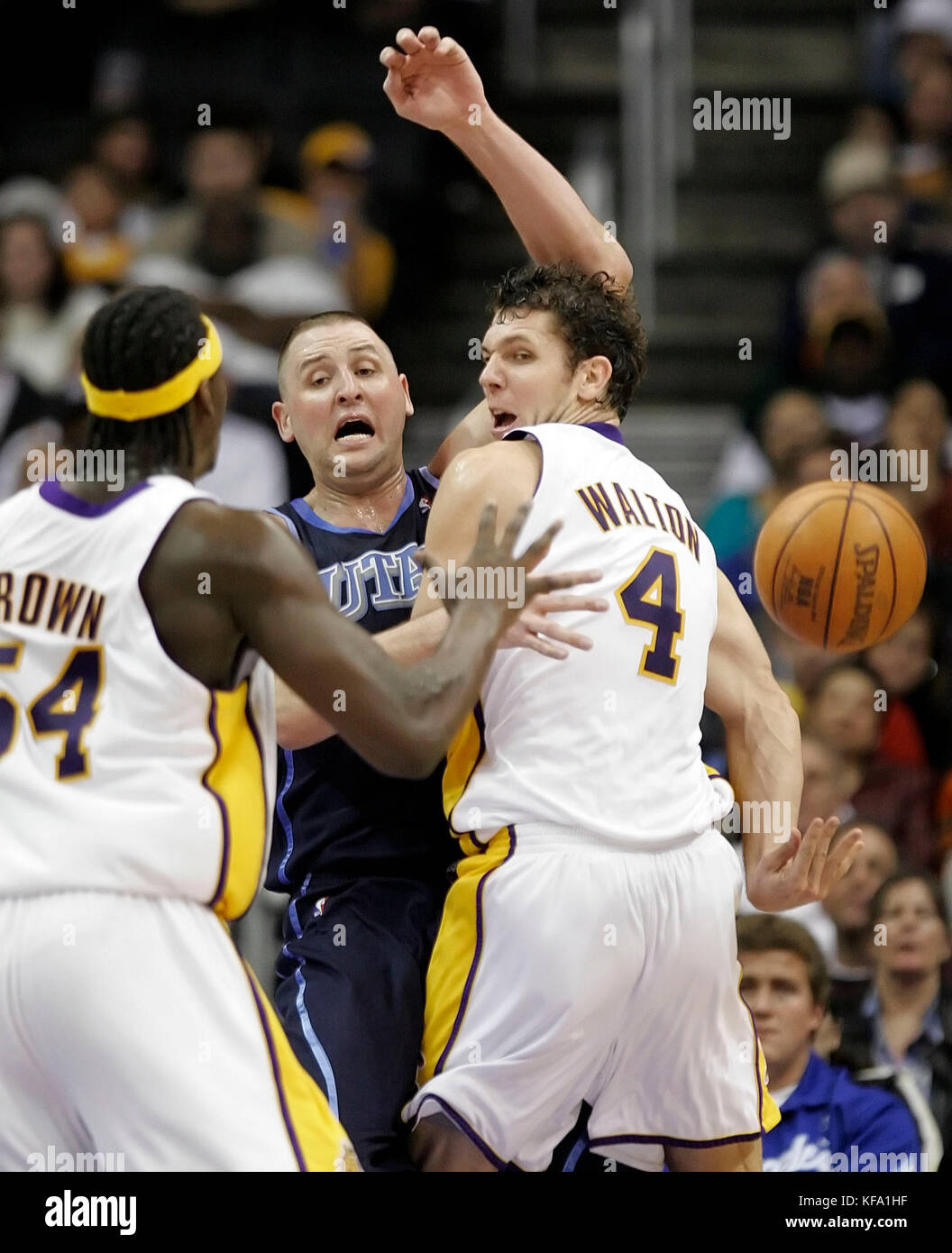 Los Angeles Lakers' Luke Walton, right, throws a behind the back pass to teammate Kwame Brown, left, as Utah Jazz's Greg Ostertag, center, defends in the first half in Los Angeles on Sunday, Jan. 1, 2006. Photo by Francis Specker Stock Photo