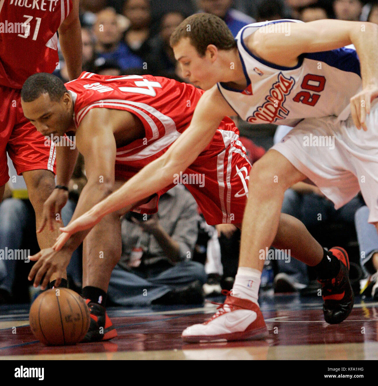 Houston Rockets' Chuck Hayes, left, grabs the loose ball away from Los Angeles Clippers' Nick Fazekas during the first half of an NBA basketball game in Los Angeles on Sunday,  April 6, 2008. Photo by Francis Specker Stock Photo