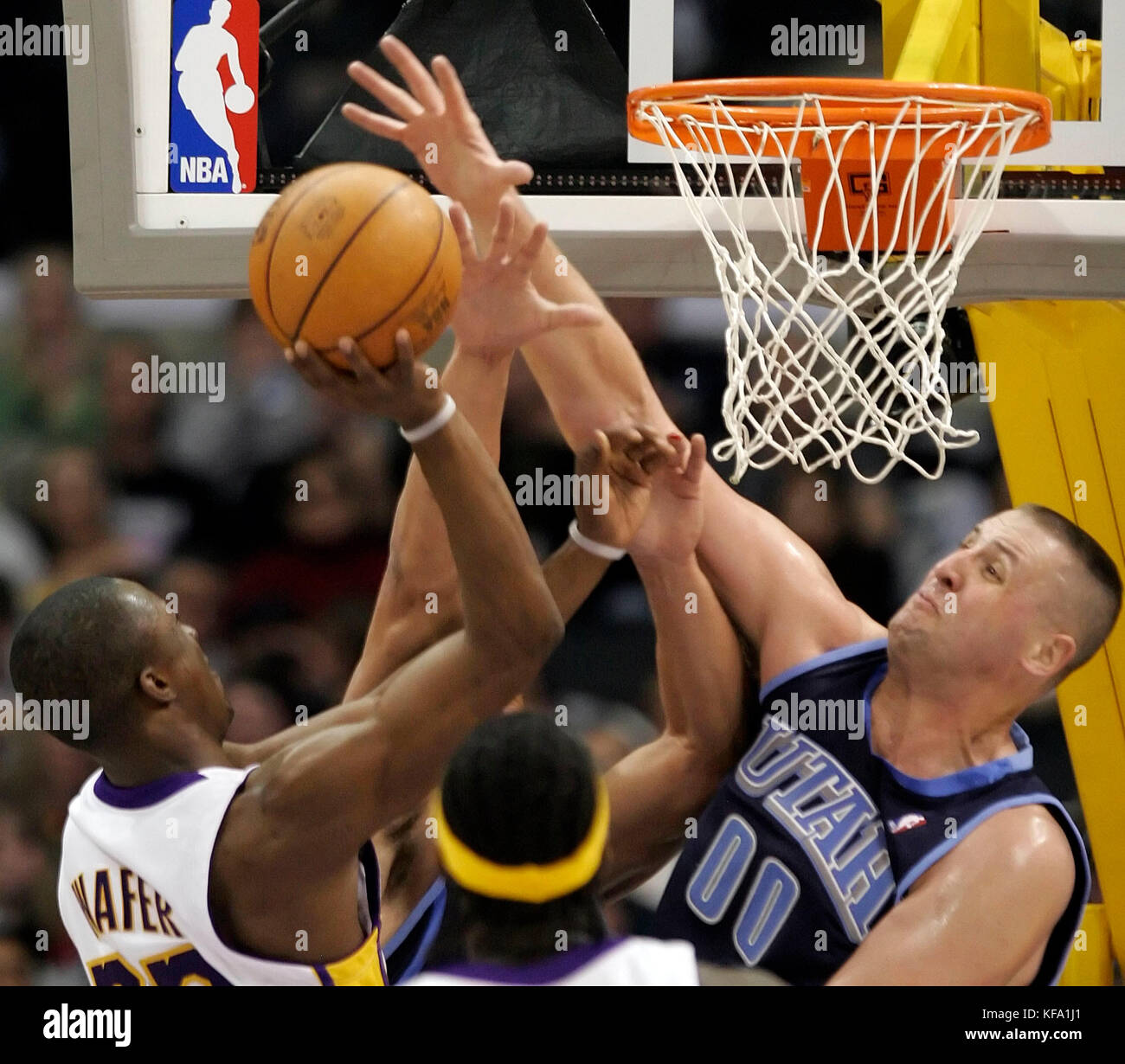 Utah Jazz's Greg Ostertag, right, tries to block a shot by Los Angeles Lakers' Von Wafer, left,  in the first half in Los Angeles on Sunday, Jan. 1, 2006. Photo by Francis Specker Stock Photo