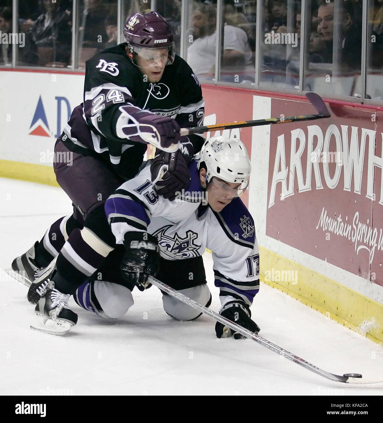 Anaheim Mighty Ducks' Ruslan Salei of Belarus, top, pushes Los Angeles Kings' Michael Cammalleri to the ice while trying to get the puck in the first period of an NHL hockey game in Anaheim, Calif. on Tuesday, April 4, 2006. Photo by Francis Specker Stock Photo