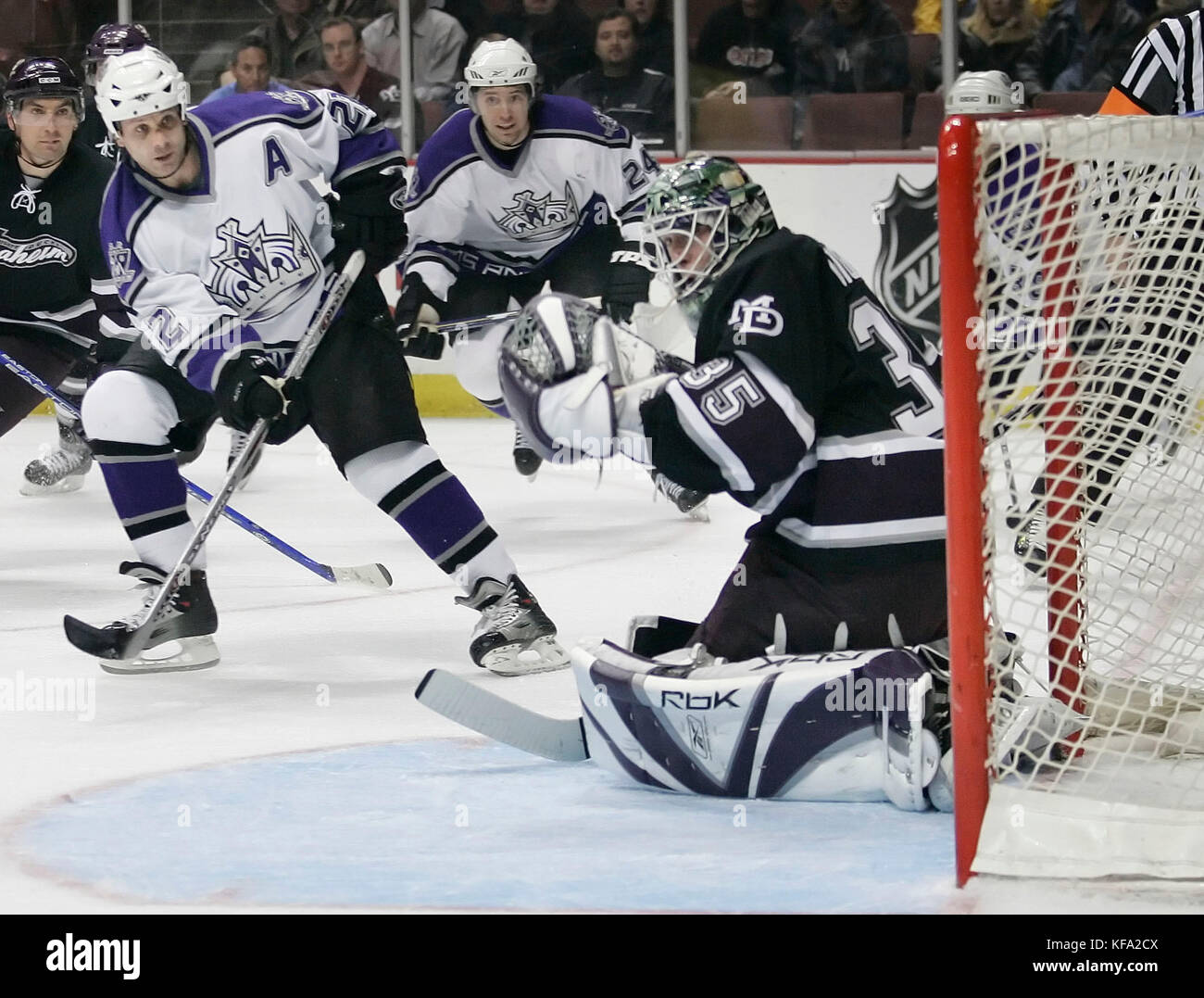 Los Angeles Kings' Craig Conroy, left, shoots the puck past Anaheim Mighty Ducks goalie Jean-Sebastien Giguere as Kings' Alexander Frolov of Russia (24) looks on in the first period of an NHL hockey game in Anaheim, Calif. on Tuesday, April 4, 2006. Frolov was credited with an assist. Photo by Francis Specker Stock Photo