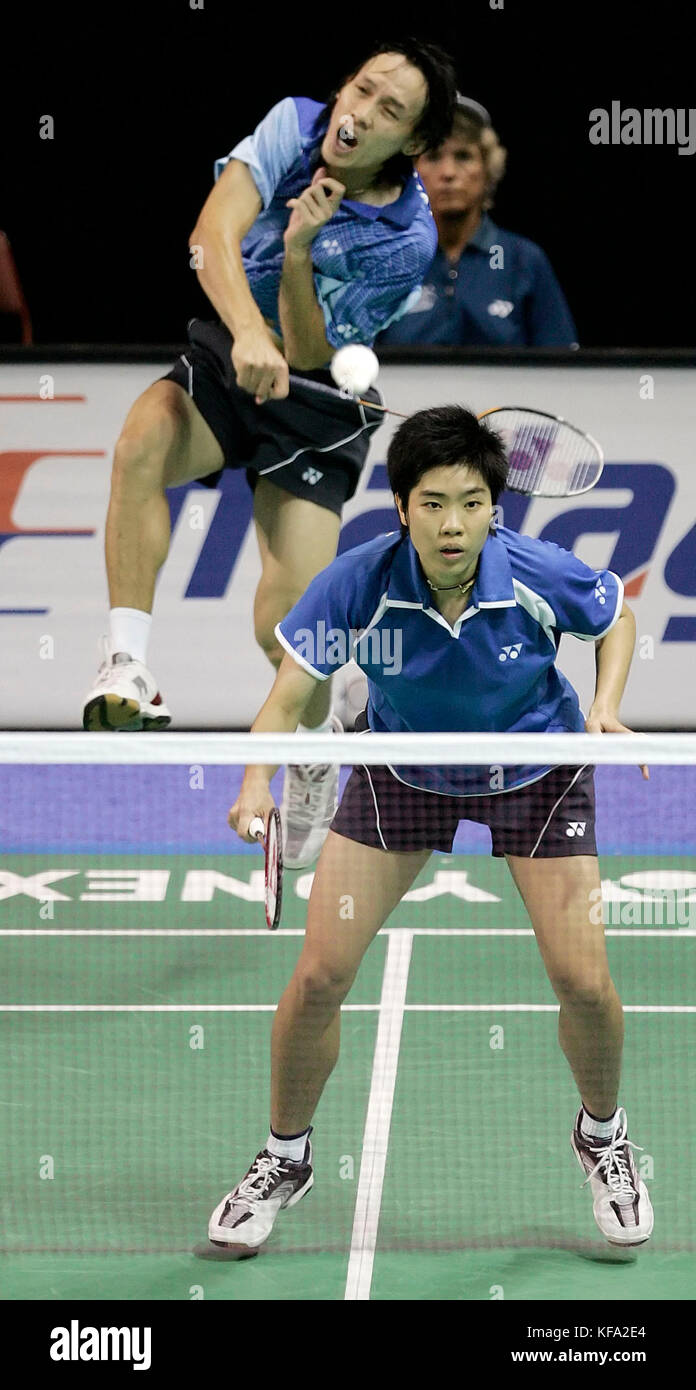 Sudket Prapakamol of Thailand, left, hits an overhead smash as