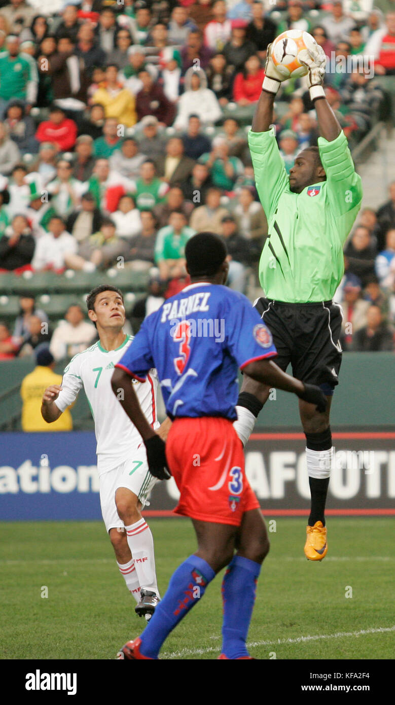 Haiti's goal keeper Johnny Placide, right, jumps into the air to retrieve  a loose ball as teammate Parnel Guerrier (3), and Mexico's Pablo Barrera (7) look on during the first half of a CONCACAF Men's Olympic Qualifying soccer tournament game in Carson, Calif., on Sunday, March 16, 2008. Photo by Francis Specker Stock Photo