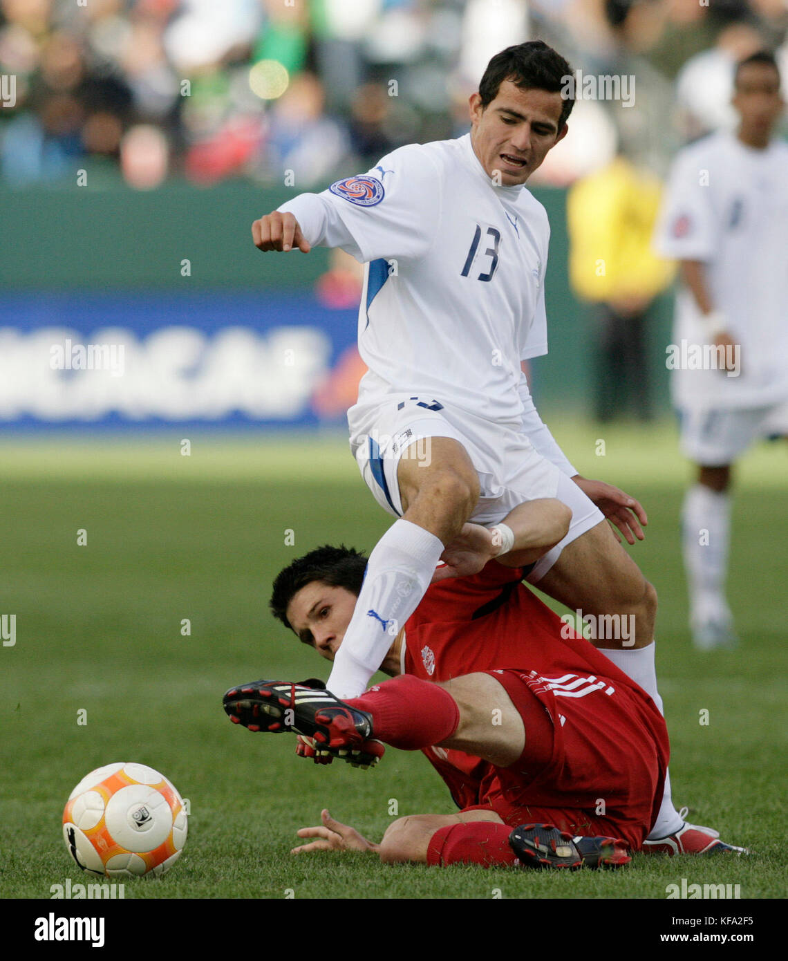 Canada's Tyler Hemming, bottom, attempts a slide tackle on