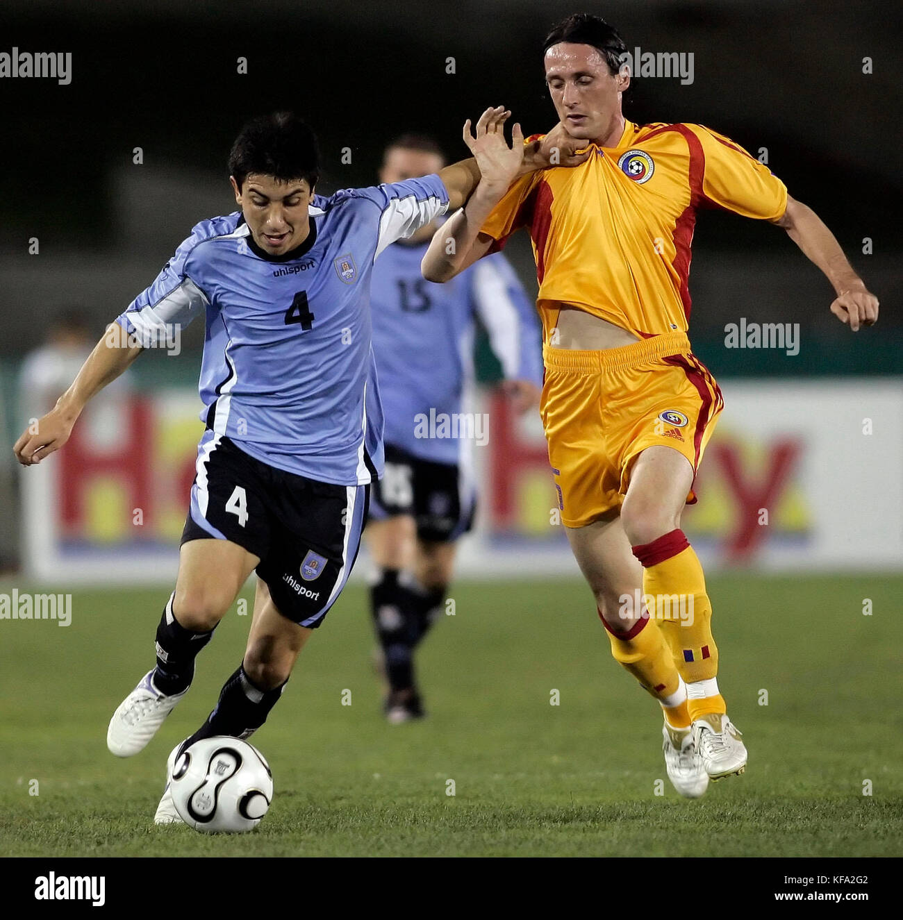 Uruguay's Jorge Fucile, left, grabs the jersey of Romania's Florin Soava during the first half of a soccer match in Los Angeles on Tuesday, May 23, 2006. Photo by Francis Specker Stock Photo
