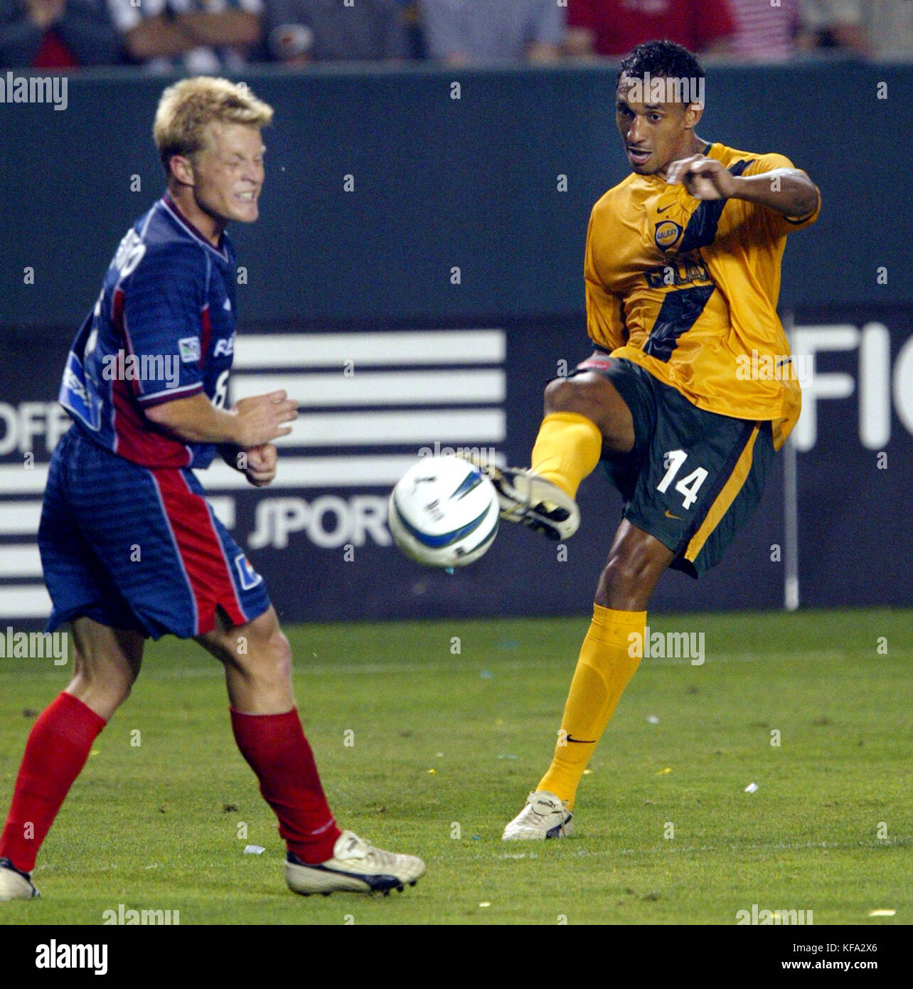 Galaxy's Tyrone Marshall, right, kicks the ball as Revolution's Joe Franchino defends during the second overtime on Friday July, 4, 2003 at the Home Depot Center in Carson, Calif. The game ended in a 2-2 tie. Photo by Francis Specker Stock Photo