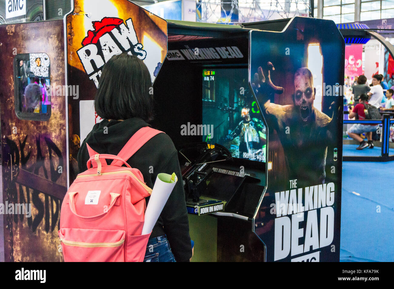 Walking Dead video game booth and female spectator Stock Photo