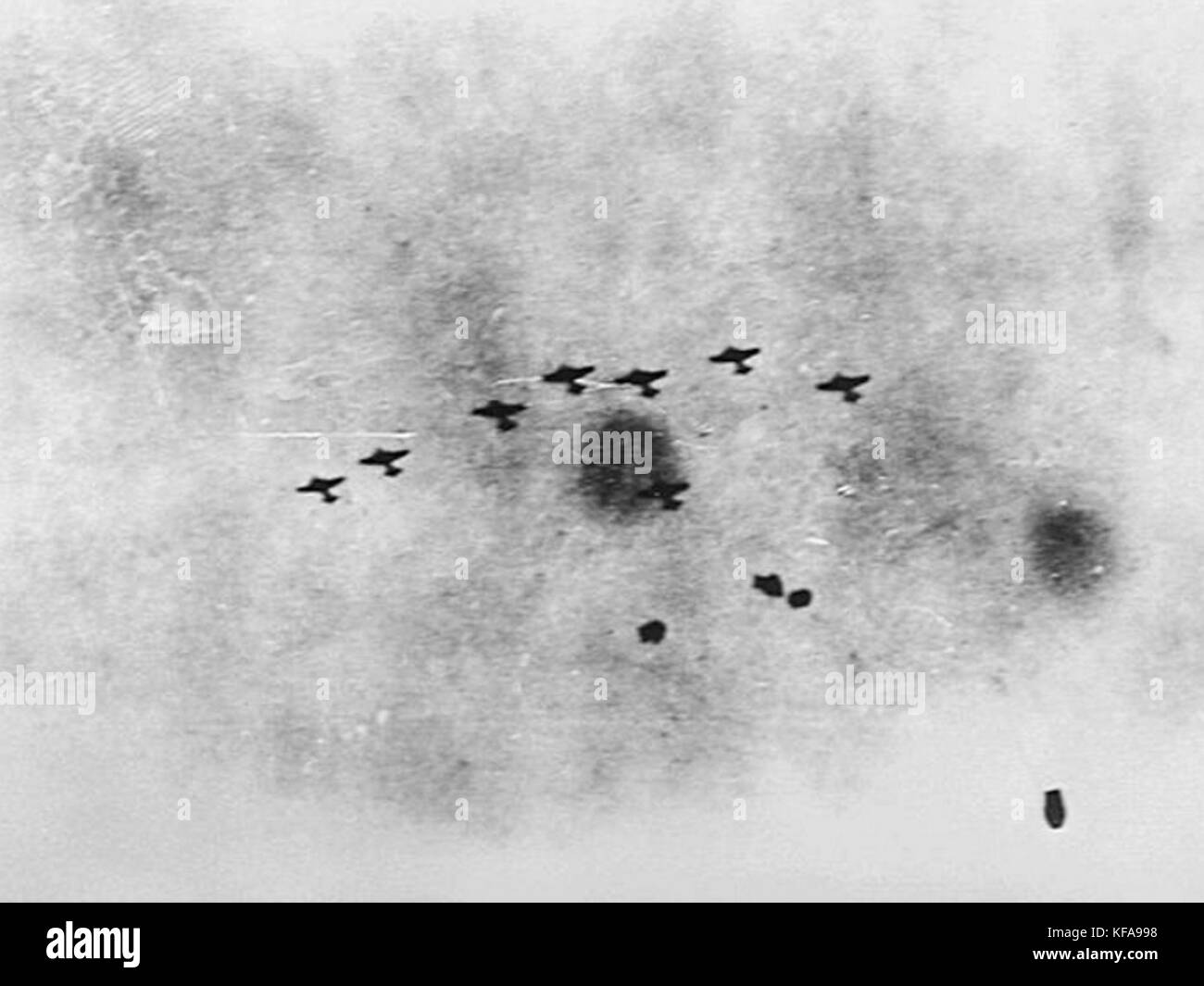 This image depicts a formation of Japanese bombers attacking warships in the Java Sea during World War II, highlighting the aerial combat and military strategy used in naval warfare. Stock Photo