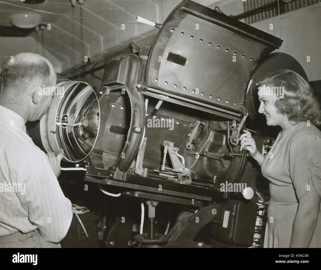 Harry Pike and unidentified woman looking at a Centrex projector, 1940   1949 (4773149205) Stock Photo