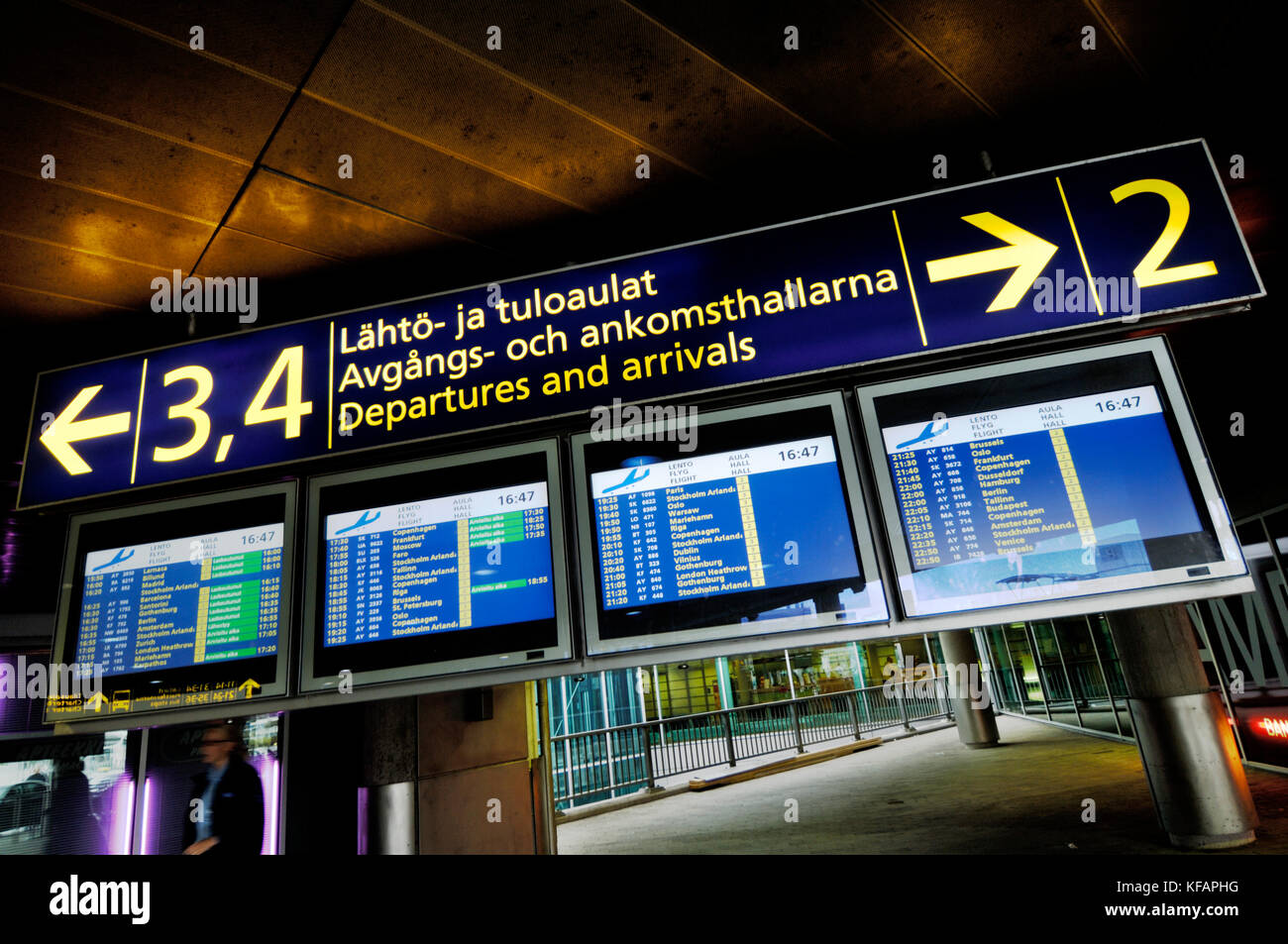 flight information screens, sign for arrivals and departures in Finnish, Swedish and English languages in Terminal2 Stock Photo