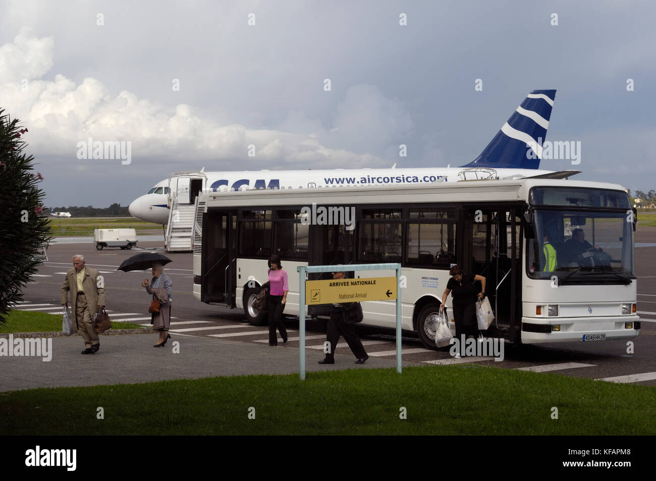 a national arrivals sign in the French and English languages with ...