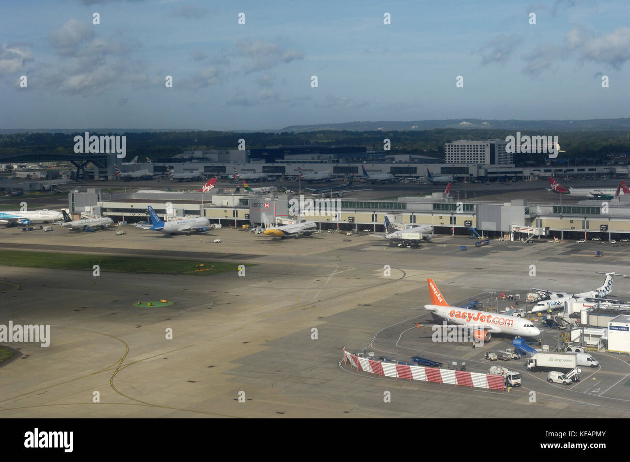 easyJet Airbus A319-100 parked on the South Terminal with the North Terminal and Hotel Sofitel behind Stock Photo