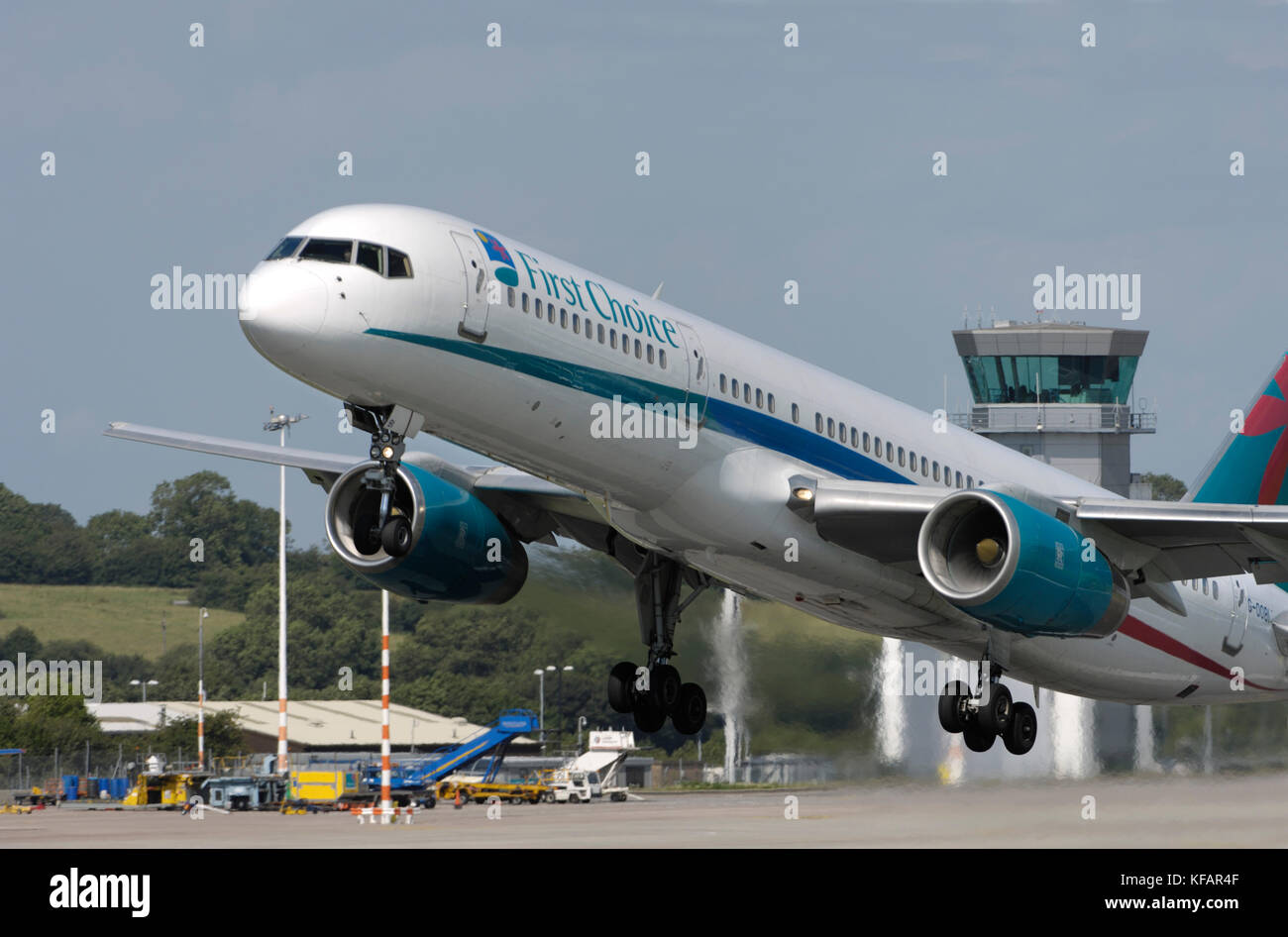 a First Choice Airways Boeing 757-200 taking-off with the air traffic control-tower behind Stock Photo