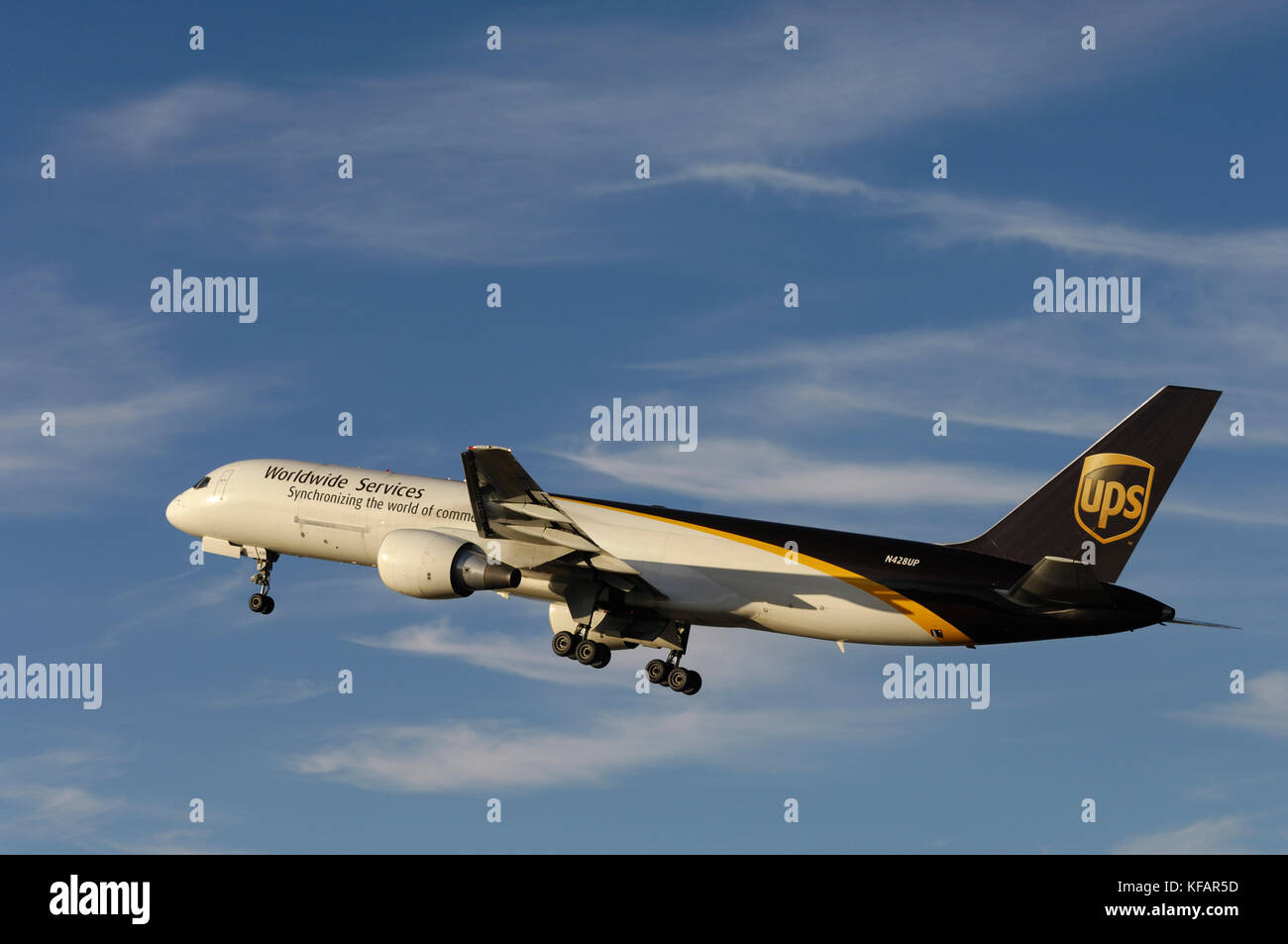 a UPS United Parcel Service Boeing 757-200 climbing out after take-off with undercarriage retracting Stock Photo