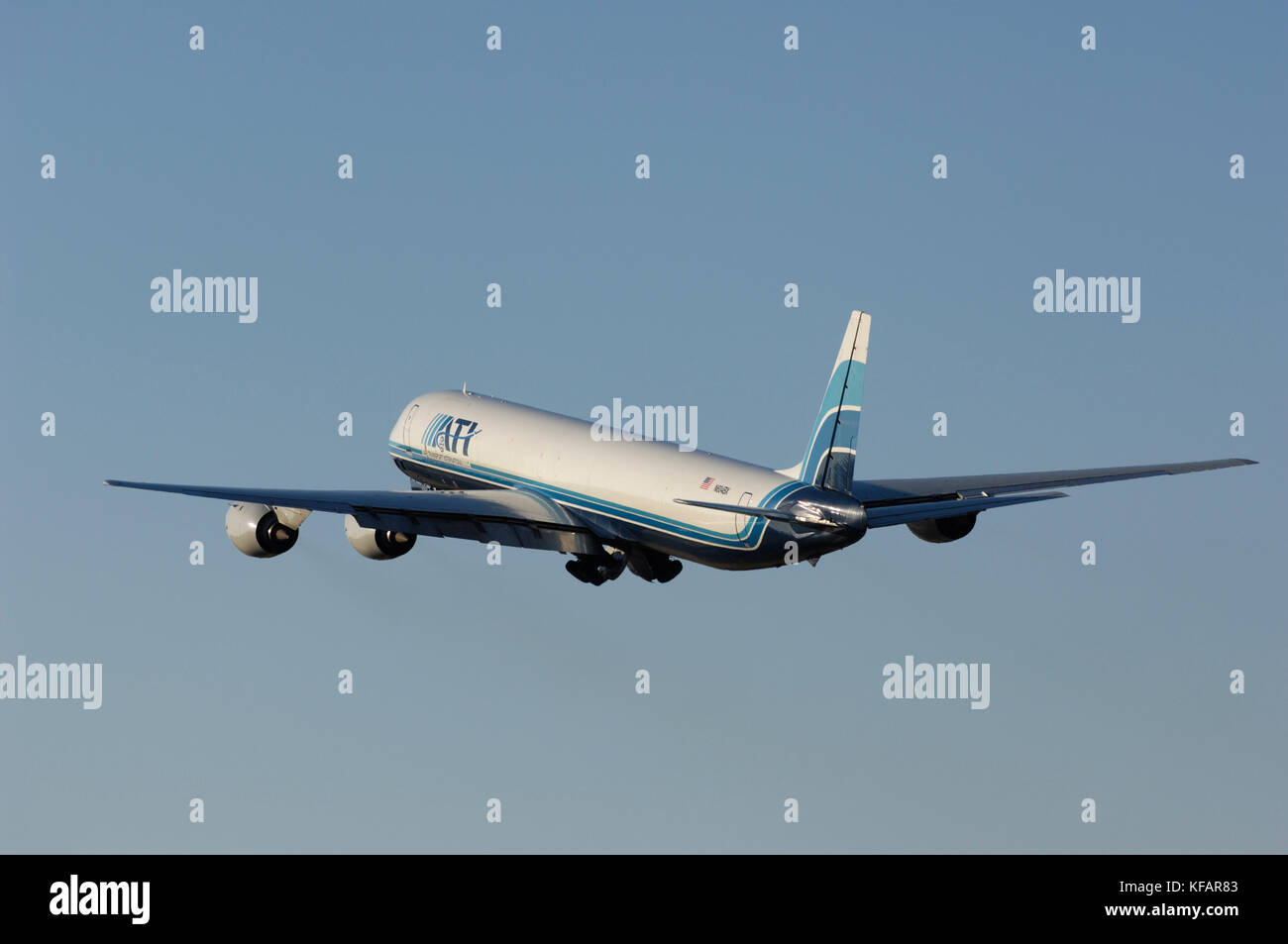 an ATI - Air Transport International McDonnell Douglas DC-8-73F climbing out after take-off with undercarriage retracting Stock Photo