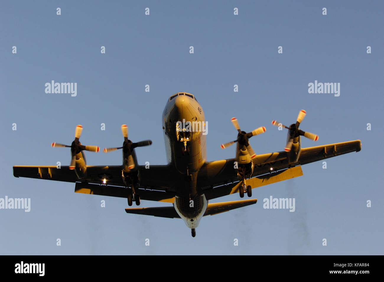 a US Navy Lockheed P-3C Orion on final-approach with black smoking-engines Stock Photo