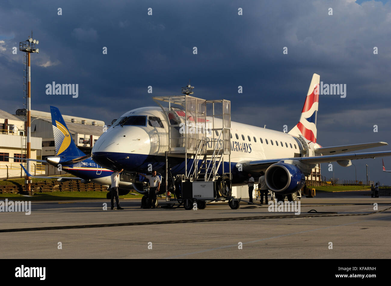 British Airways BA CityFlyer Embraer 170-100STD and tail-fin of JetBlue 190-200AR with 'mosaic' tail-fin special-livery parked behind Stock Photo