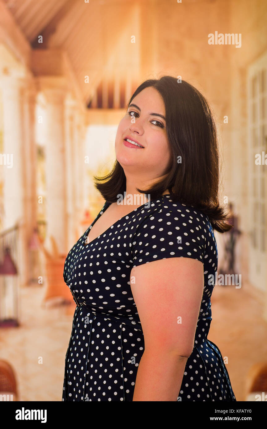 Close up of young beautiful plus size model in black dress, xxl woman in  blurred studio background Stock Photo - Alamy
