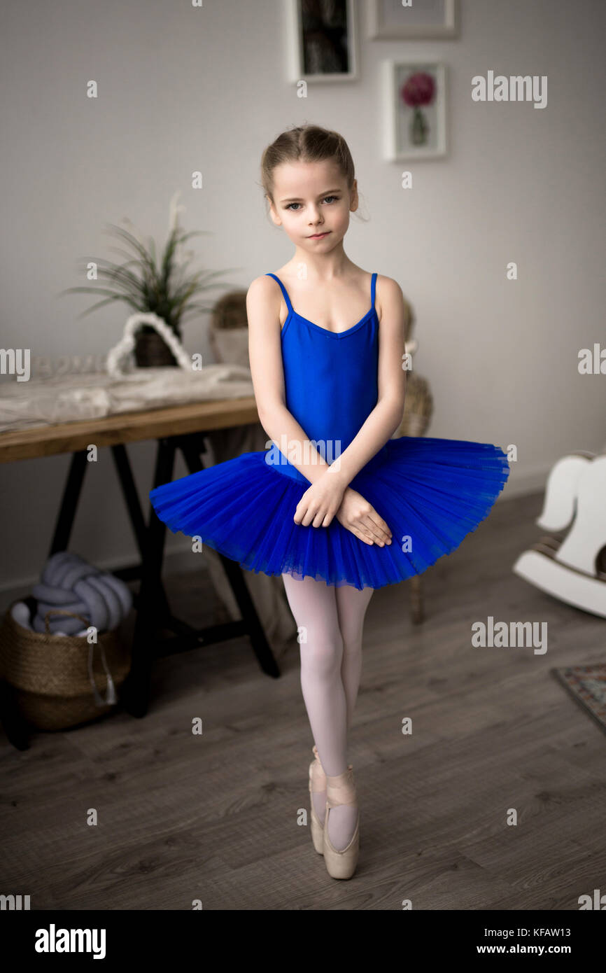 Cute little ballerina in pink ballet costume and pointe shoes is dancing in  the room. Child girl is studying ballet Stock Photo - Alamy