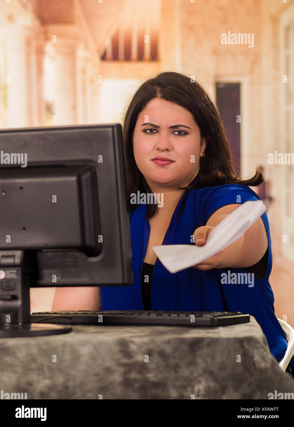 Portrait of fat woman working in the office while sitting in front of