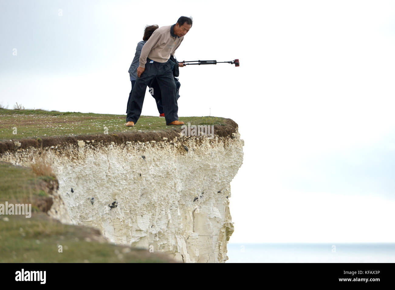 Tourists taking risky selfies on a cliff edge of the Seven Sisters at Birling Gap, East Sussex. Stock Photo