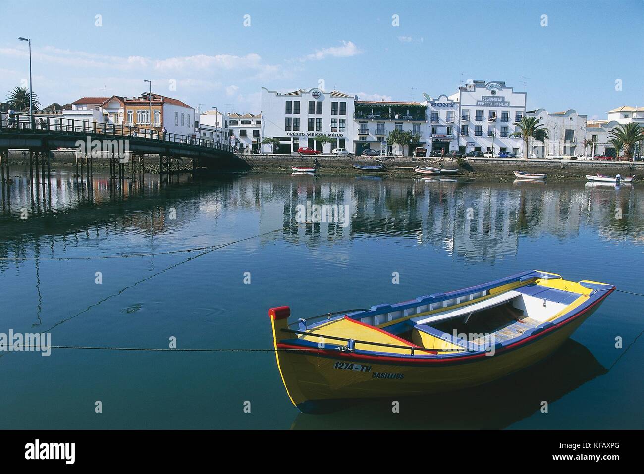 Portugal, Tavira, Houses along the mouth of the Rio Sequa. Fishing boat in the foreground Stock Photo