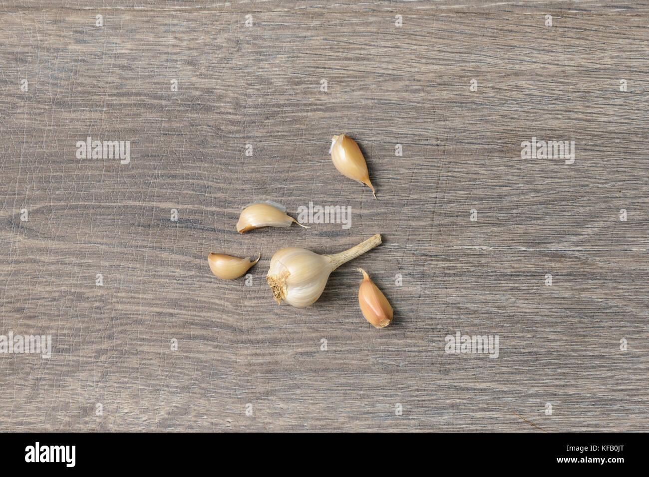 Garlic scattered on wooden table Stock Photo