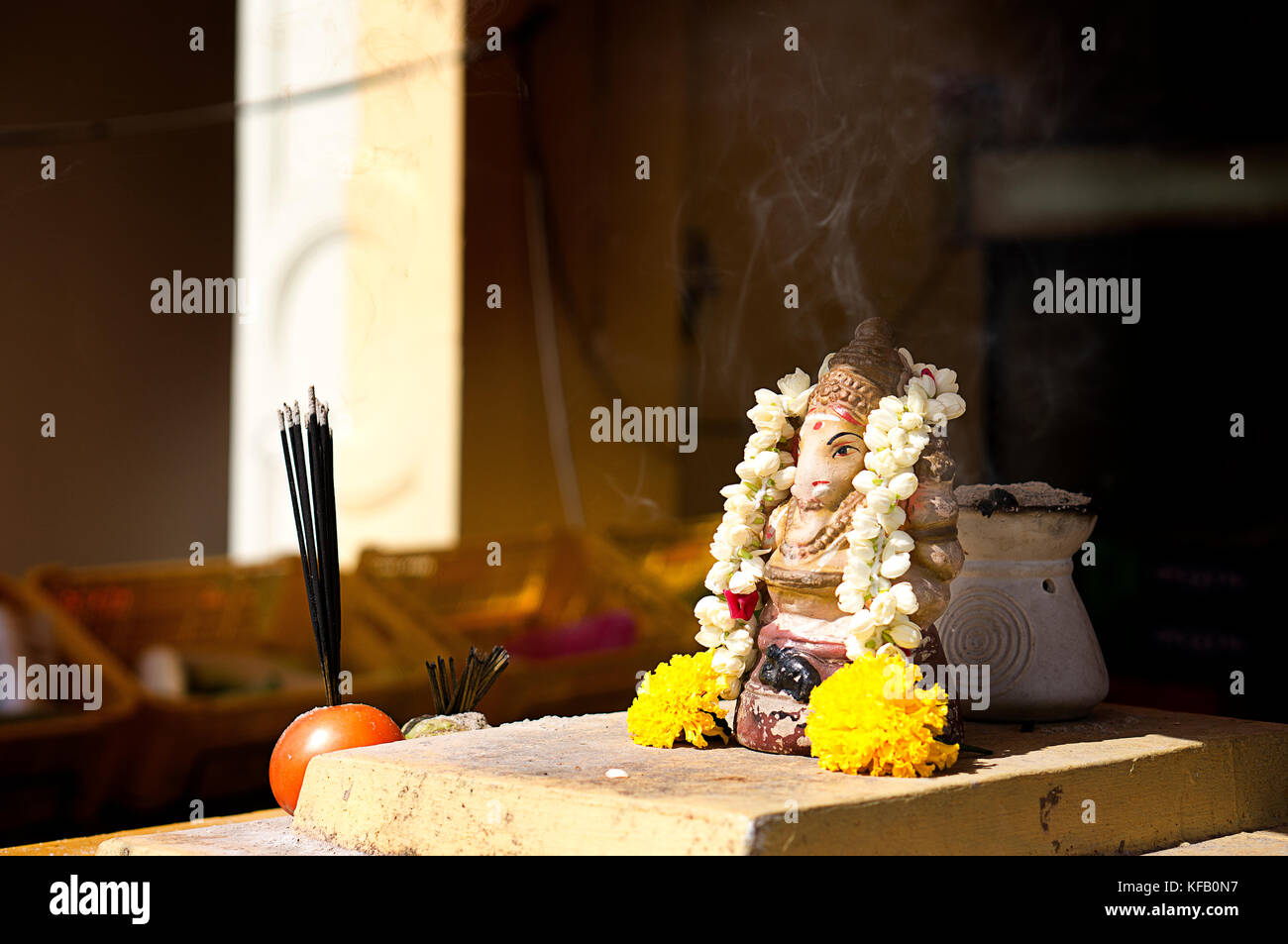 Shrine with incense burning on street in Little India, Singapore Stock Photo