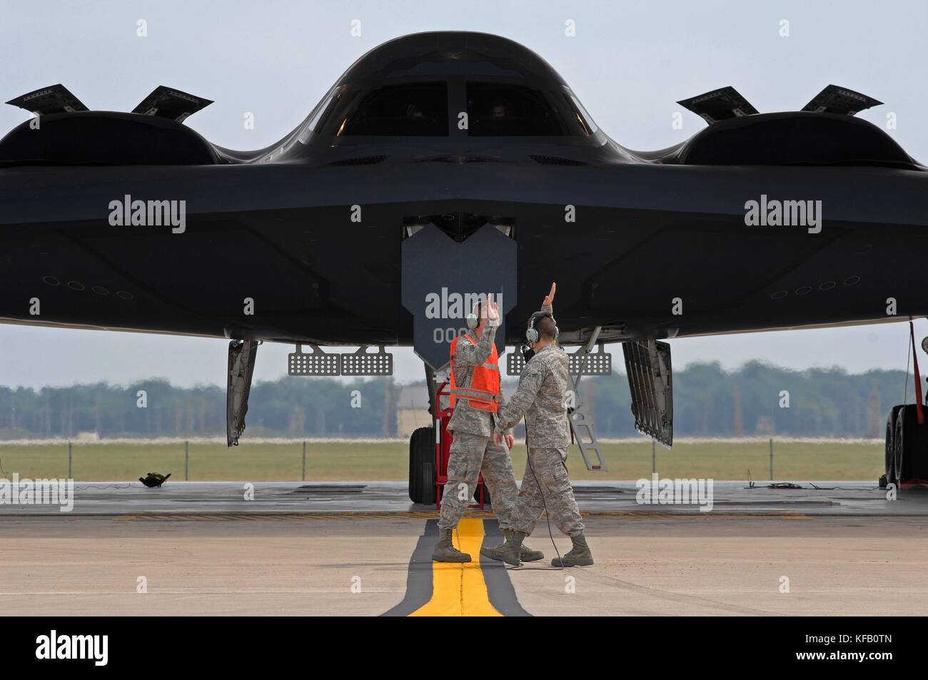 U.S. Air Force pilots give each other a high-five on the runway in front of a U.S. Air Force B-2 Spirit stealth bomber aircraft at the Whiteman Air Force Base September 8, 2009 near Knob Noster, Missouri.    (photo by Kenny Holston via Planetpix) Stock Photo