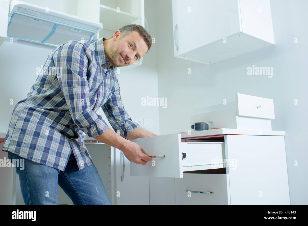 man opening a kitchen drawer Stock Photo Alamy