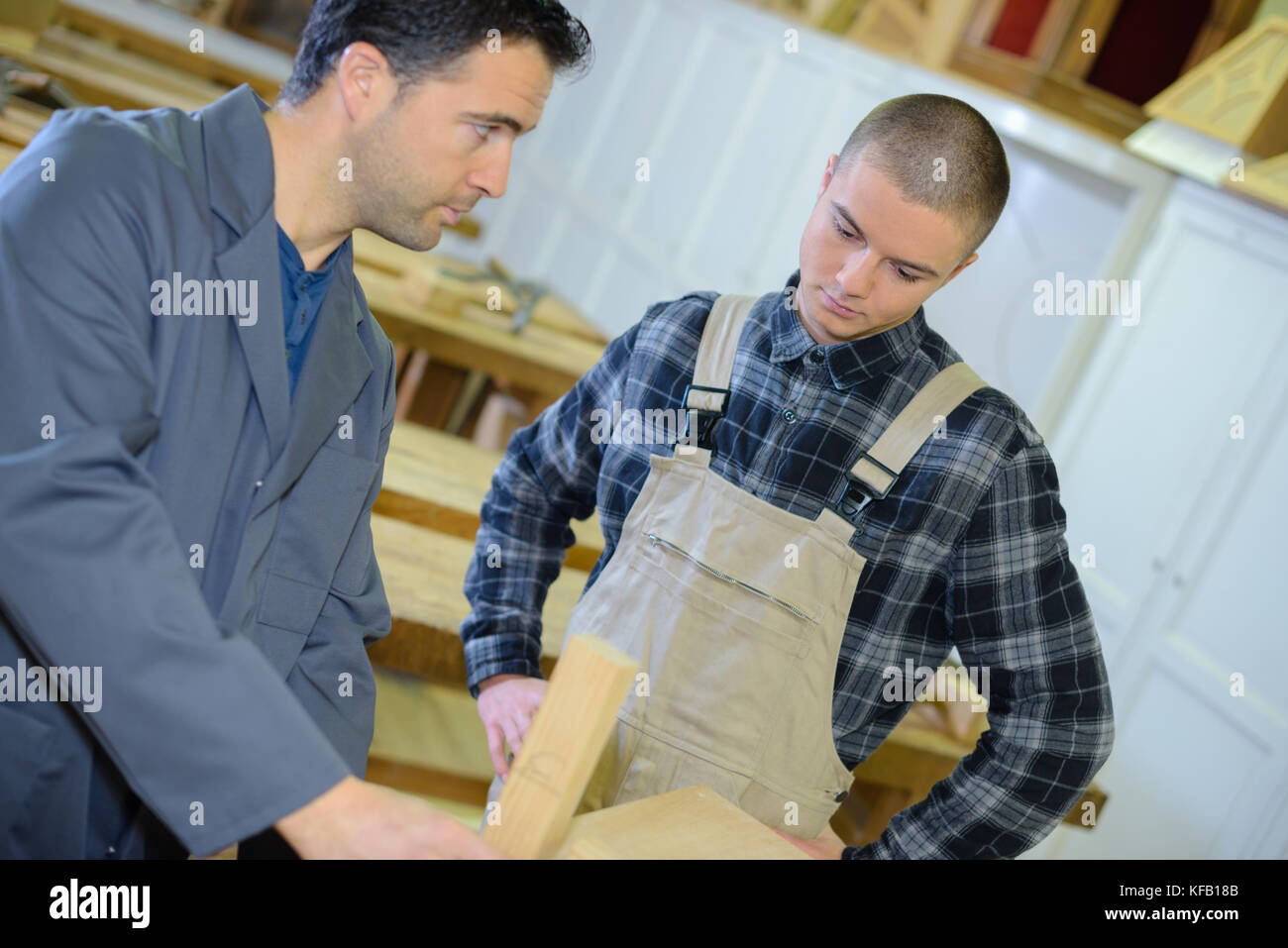 experienced carpenter teaching teenage boy Stock Photo - Alamy