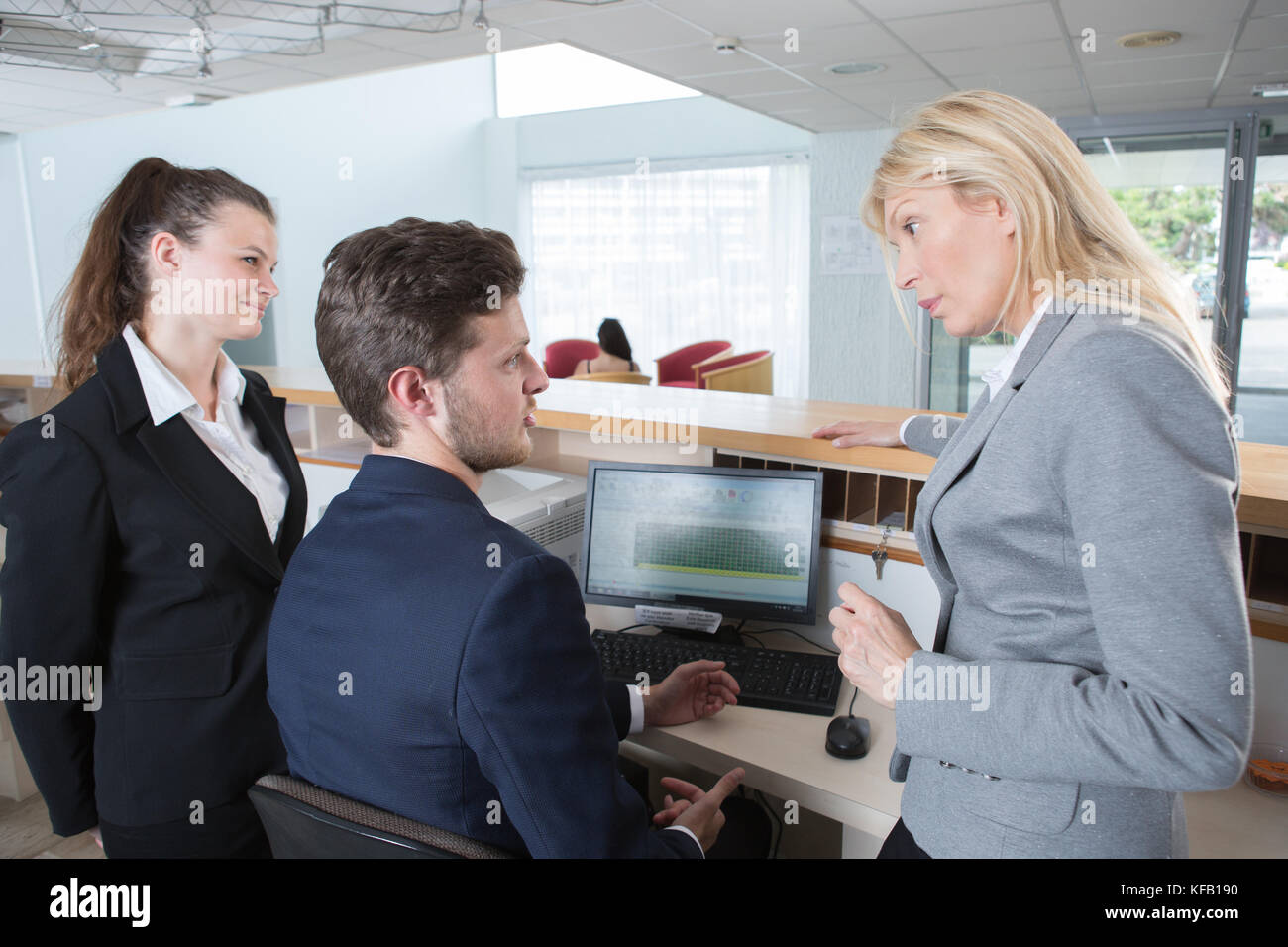 hotel manager with apprentice on reception Stock Photo - Alamy