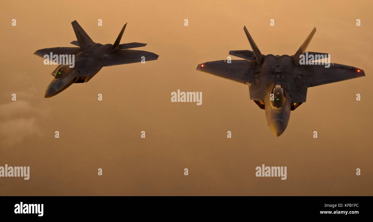 Two U.S. Air Force F-22 Raptor stealth tactical fighter aircraft fly in formation at sunset August 21, 2012 over New York.   (photo by Kenneth W. Norman via Planetpix) Stock Photo