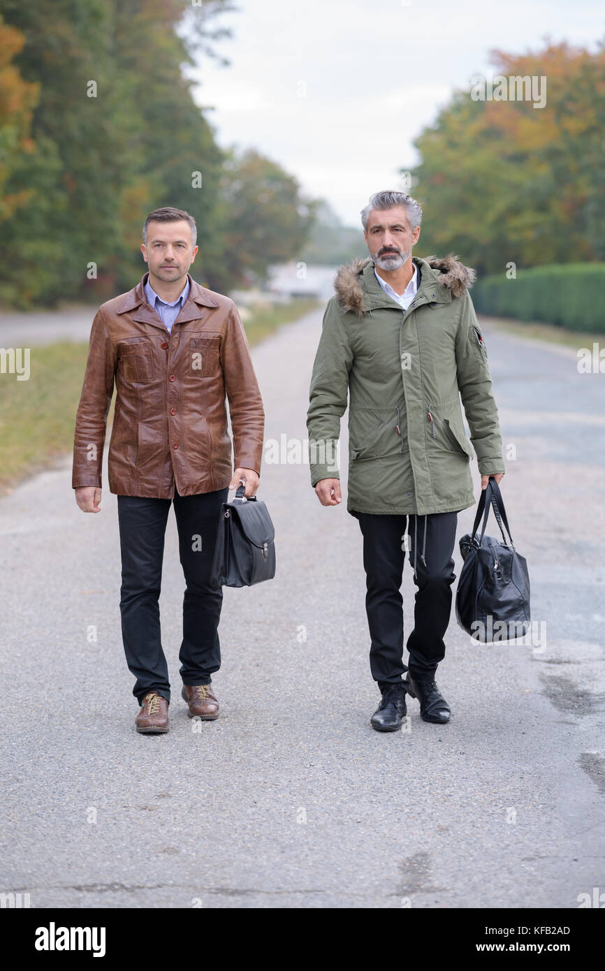 two businessmen walking together outside the office in the city Stock ...