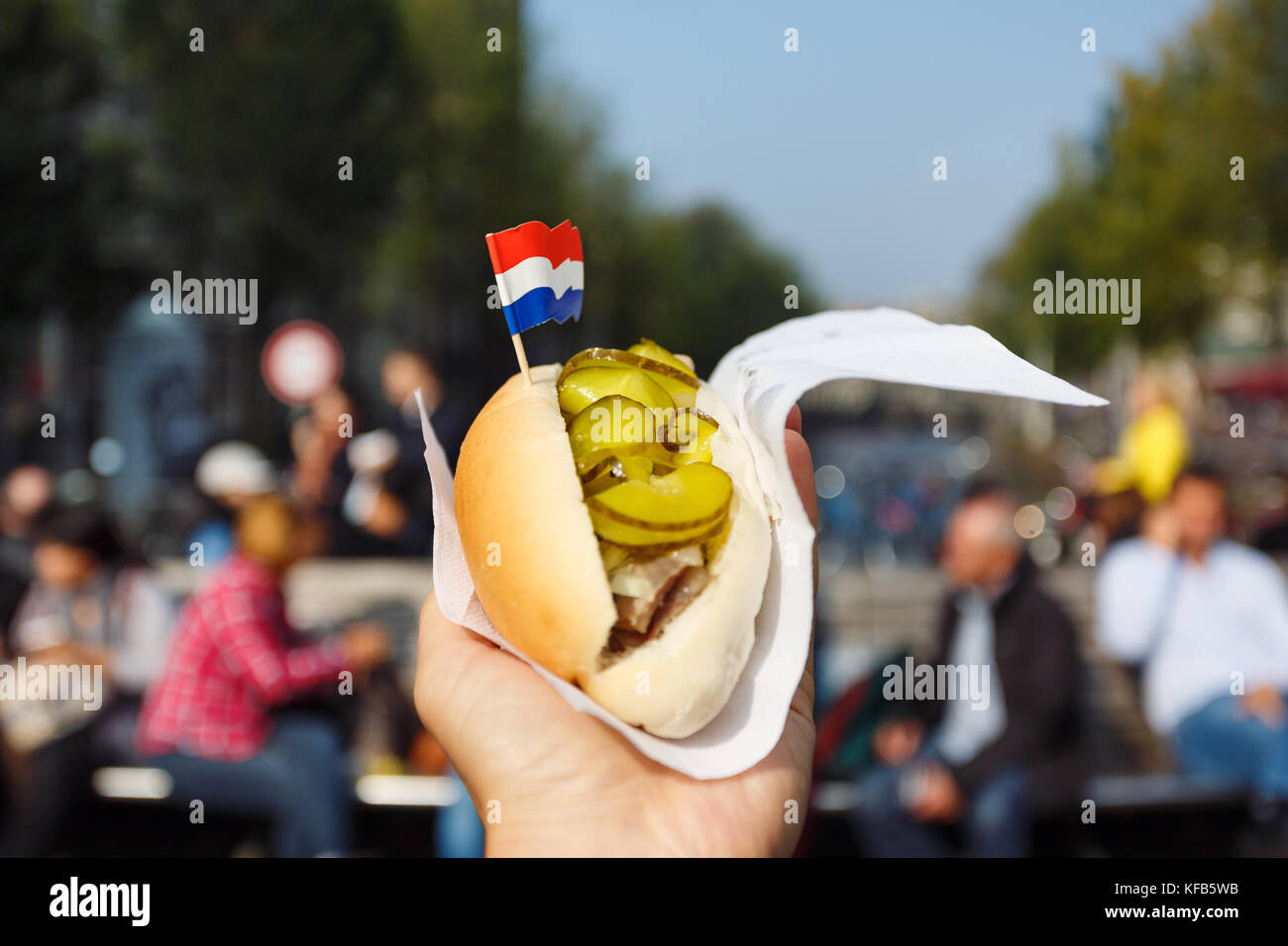 Traditional dutch sandwich with herring in a hand outdoors Stock Photo Alamy