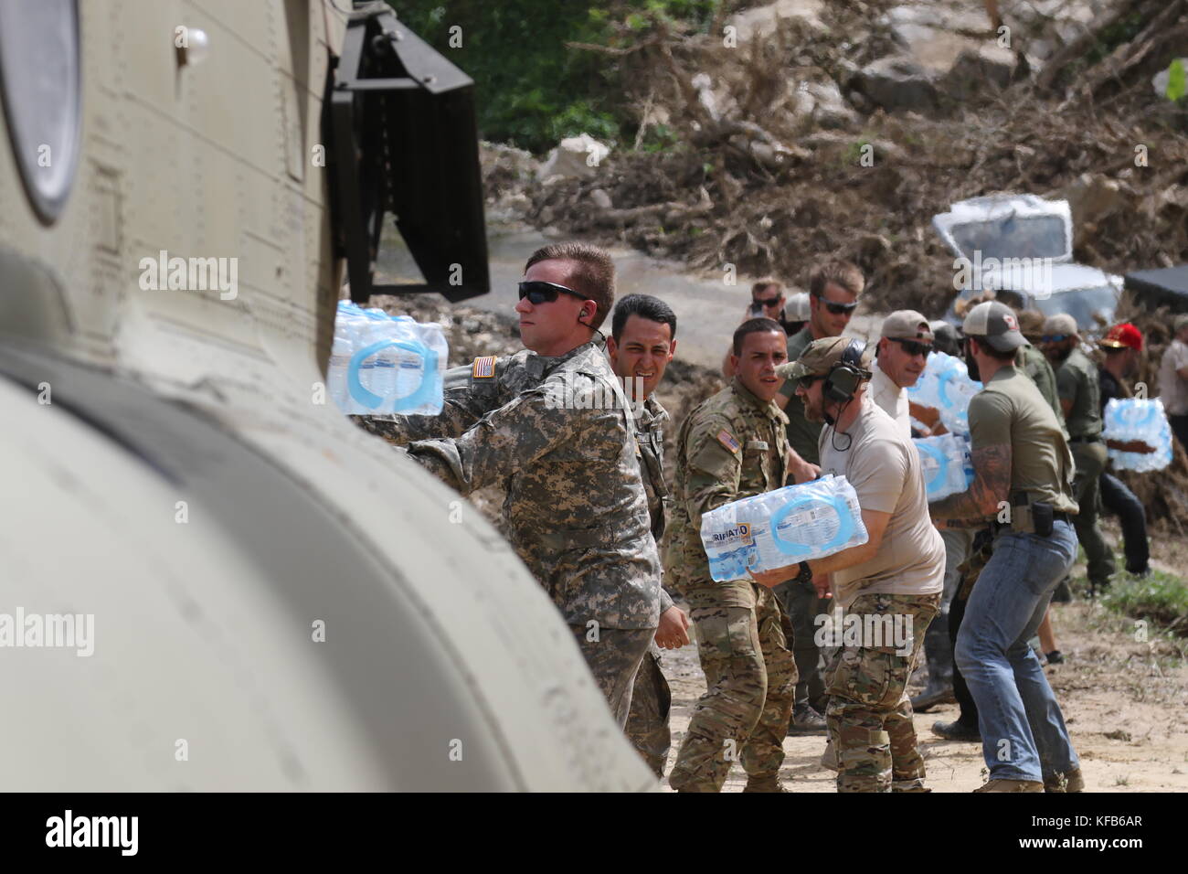 U.S. Army soldiers unload emergency supplies from a CH-47 Chinook helicopter during relief efforts in the aftermath of Hurricane Maria October 18, 2017 in Utuado, Puerto Rico.   (photo by Tyson Friar via Planetpix) Stock Photo
