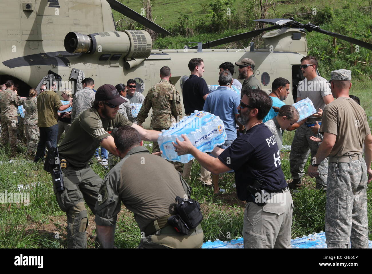 U.S. Army soldiers and U.S. Department of Homeland Security officers unload emergency supplies from a CH-47 Chinook helicopter during relief efforts in the aftermath of Hurricane Maria October 19, 2017 in Coamo, Puerto Rico.   (photo by Tyson Friar via Planetpix) Stock Photo