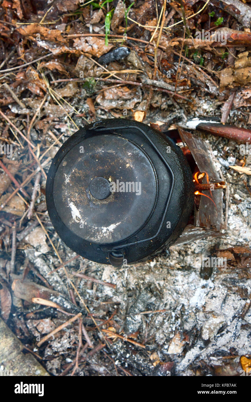 Cooking teapot over open fire at campsite Stock Photo Alamy