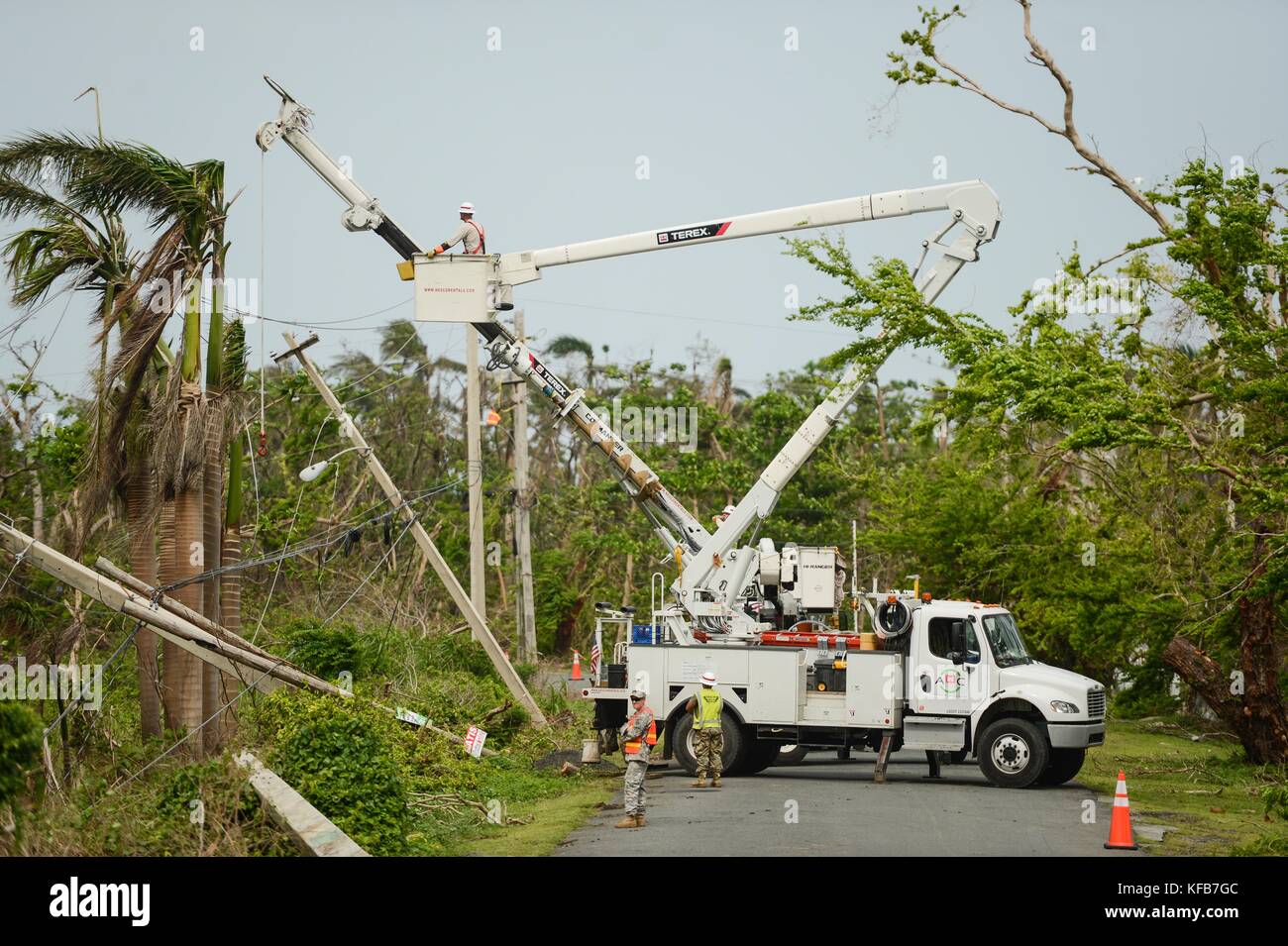 U.S. Army soldiers and Prime Power employees repair power lines during relief efforts in the aftermath of Hurricane Maria October 19, 2017 in Rio Grande, Puerto Rico.     (photo by Joshua L. DeMotts via Planetpix) Stock Photo