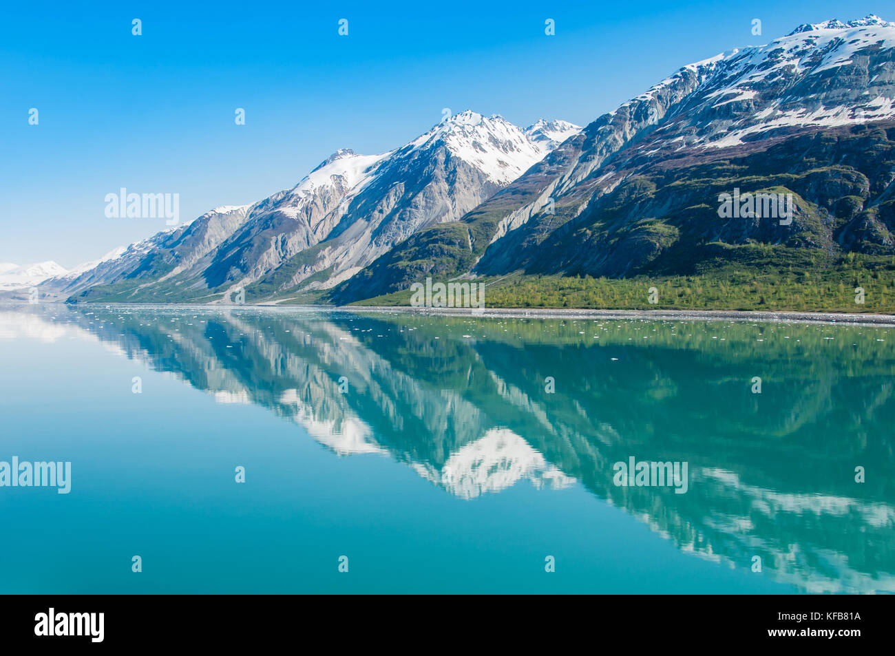 Reflection of the mountains in still water of Glacier Bay, Alaska