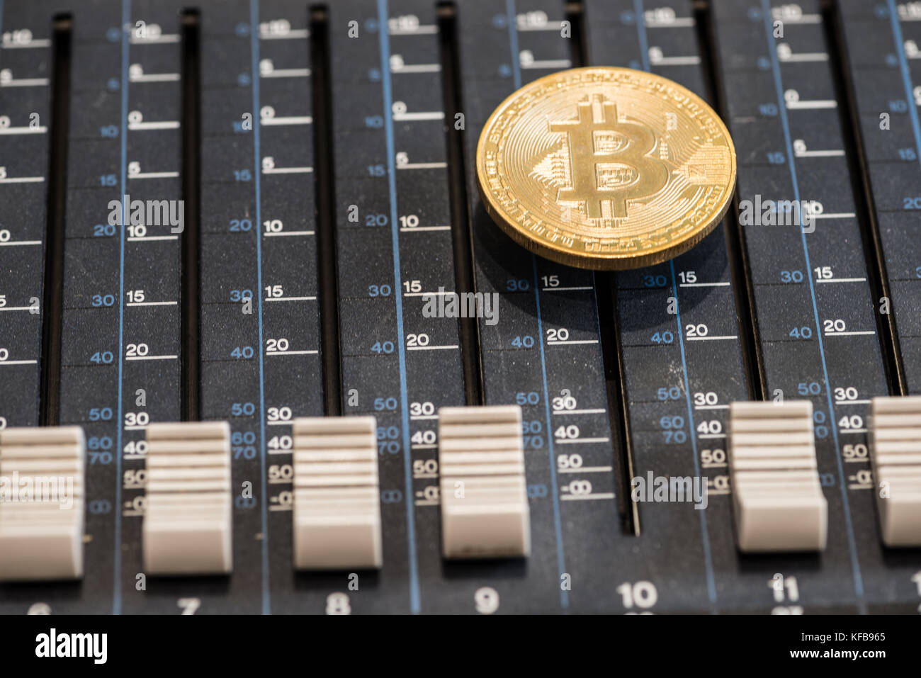 Bitcoin coin on the sound mixer console. Concept idea Stock Photo - Alamy