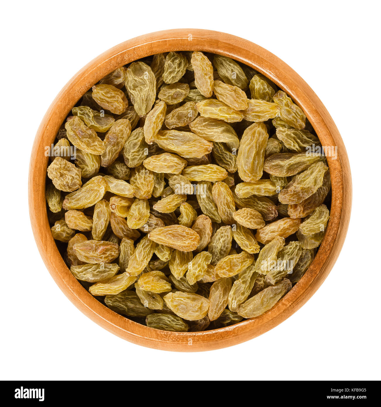 Green raisins in wooden bowl. Dried grapes. Vitis. Green seedless sultana variety from Asia. Eaten raw or used in cooking and baking. Photo. Stock Photo