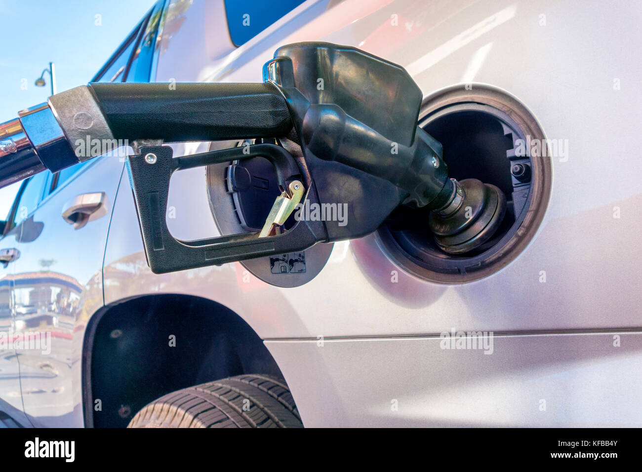Gas pump nozzle. Petrol pump nozzle with vapor recovery. Fueling a big SUV in the US. Stock Photo