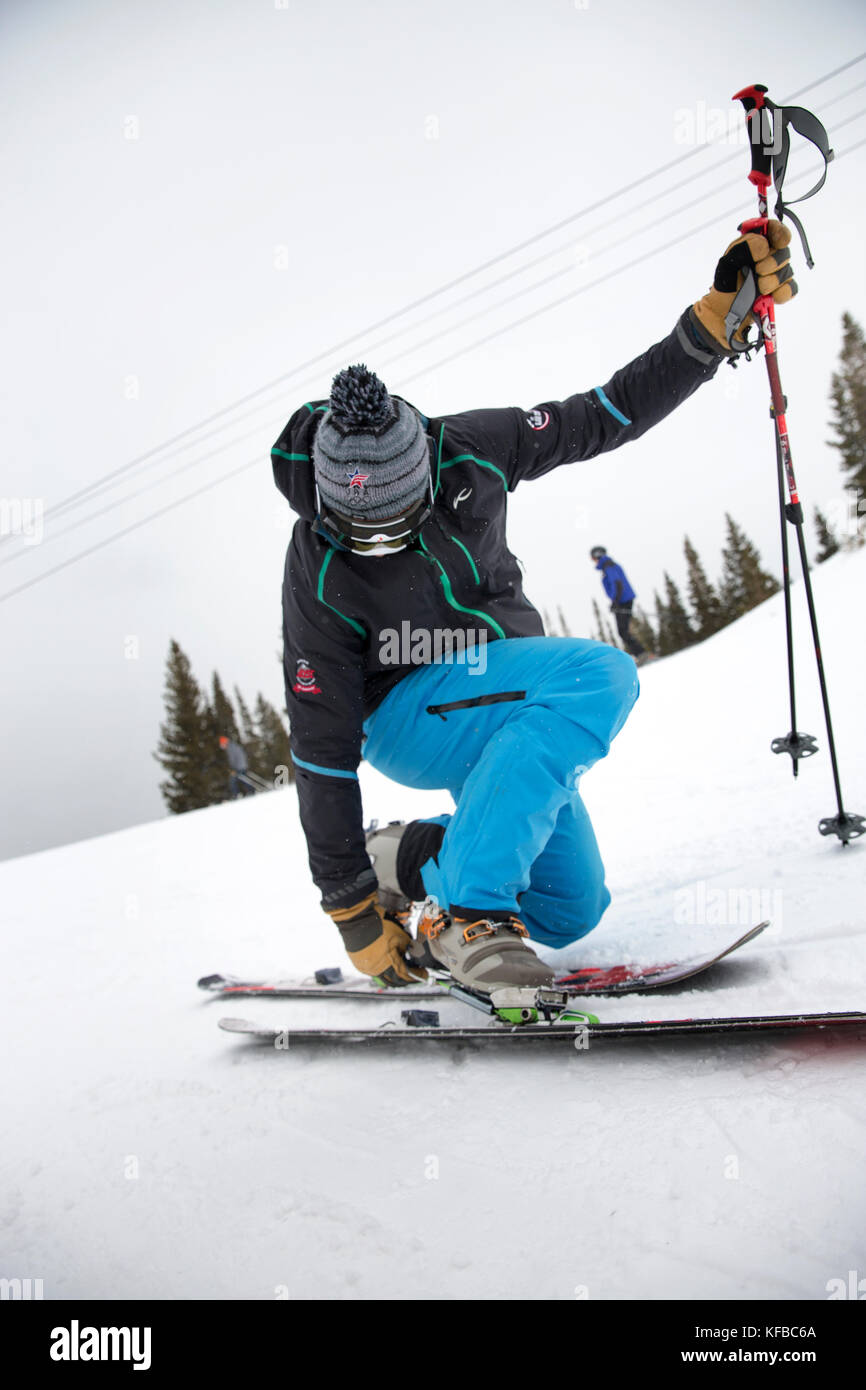 USA, Colorado, Aspen, a telemark skier puts on his skiis outside the Cloud Nine Restaurant, Aspen Highlands Ski Resort Stock Photo