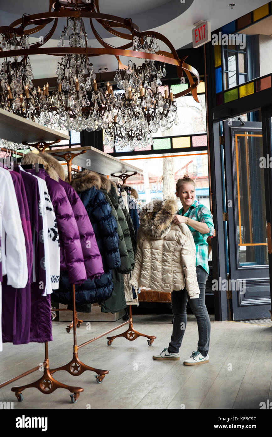 USA, Colorado, Aspen, a young woman shops at store called Jet Set in downtown Aspen Stock Photo