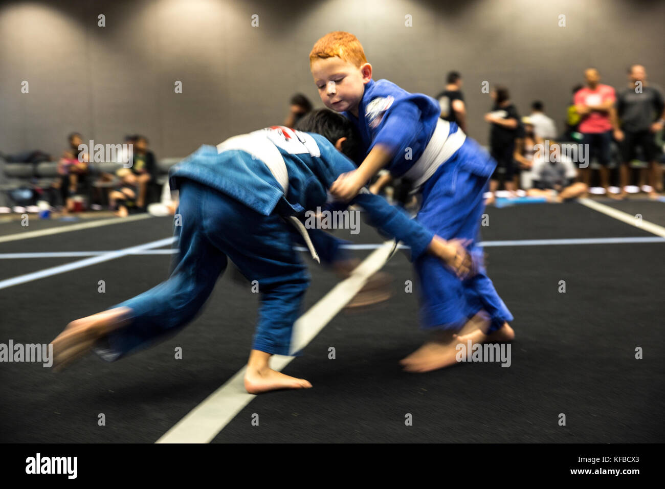 USA, Oahu, Hawaii, young boy Jujitsu Martial Arts fighters grapple at