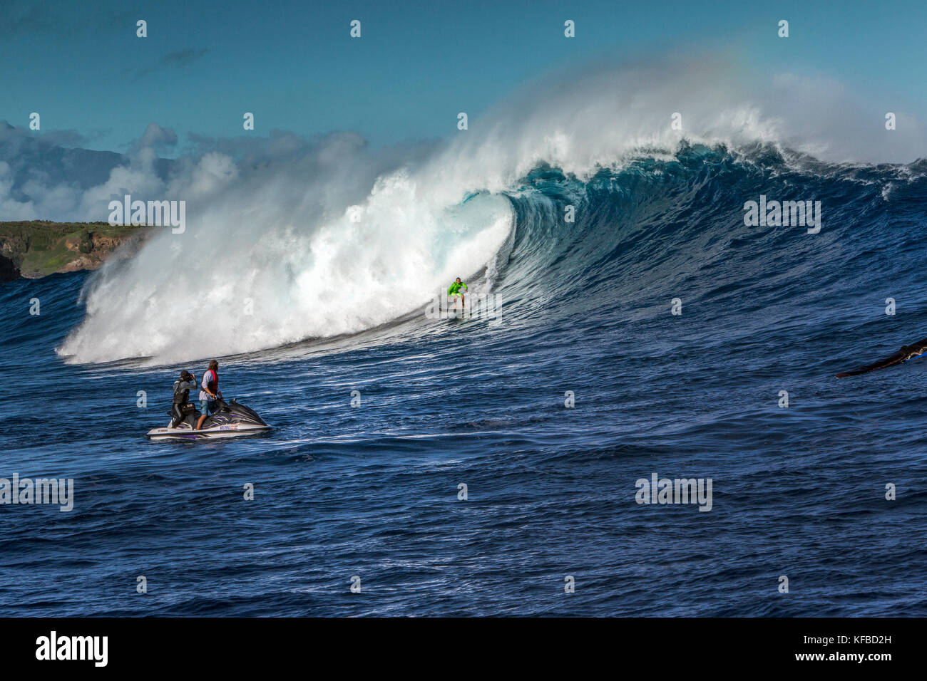 USA, HAWAII, Maui, Jaws, big wave surfers taking off on a wave at Peahi