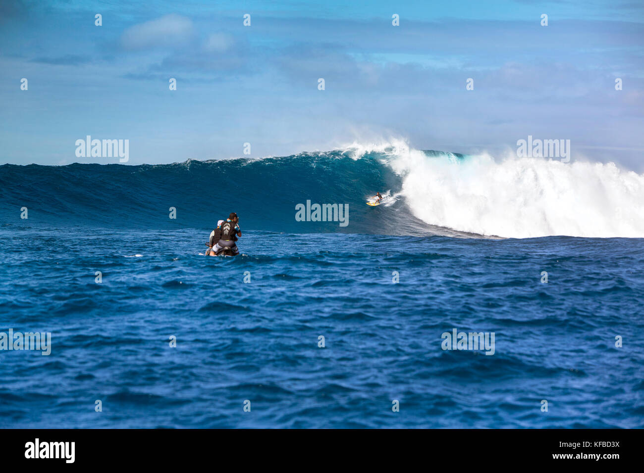 USA, HAWAII, Maui, Jaws, big wave surfers taking off on a wave at Peahi